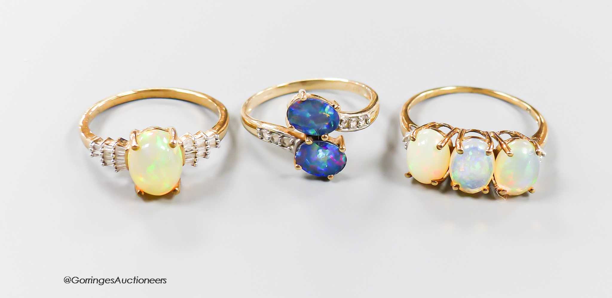 Two modern 9ct gold, opal and diamond set dress rings, size P & P/Q and one other 9ct gold and two stone opal doublet set dress ring, gross weight 6.8 grams.